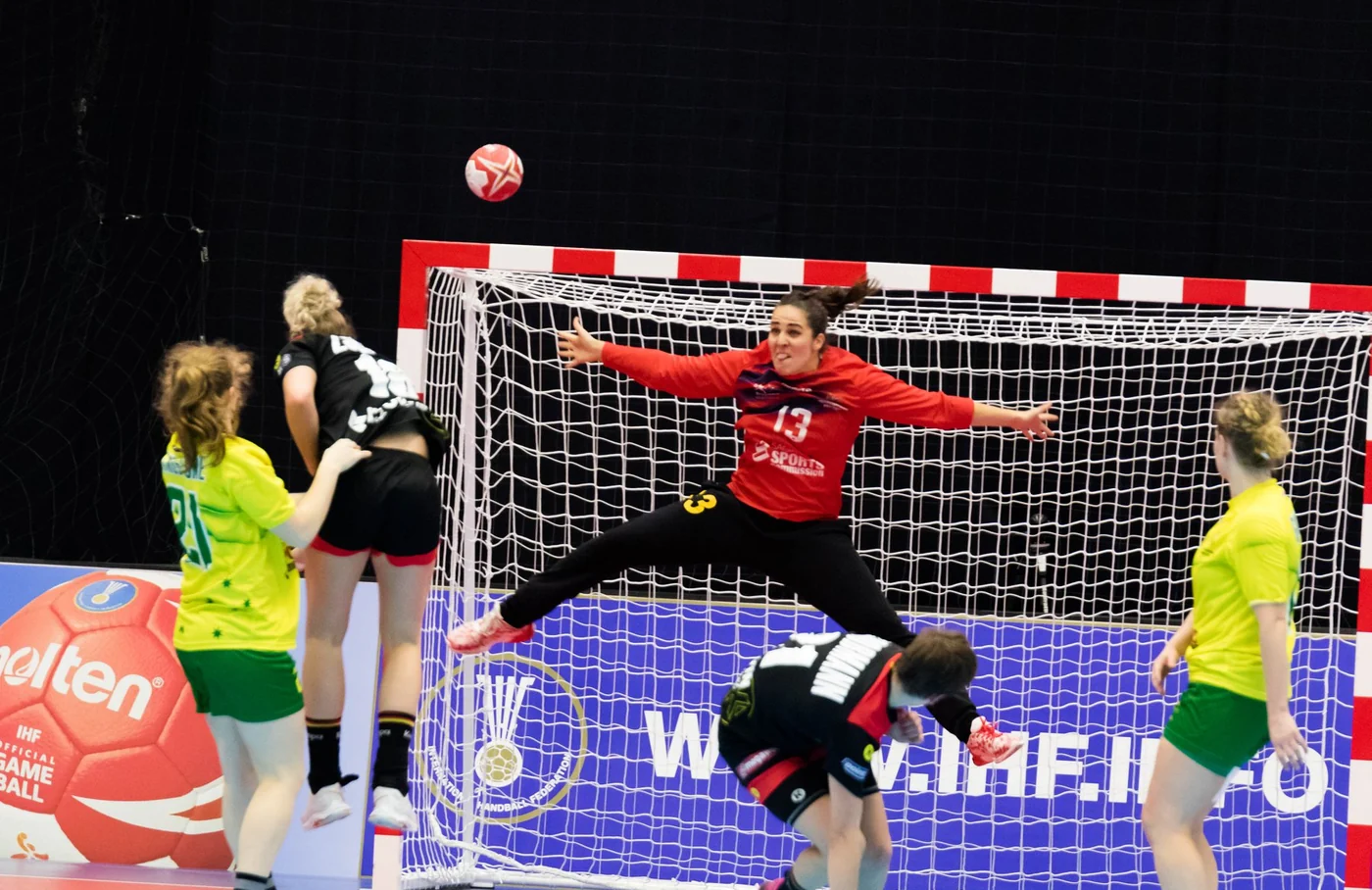 Manon Vernay stretching across the goal to make a save at an IHF tournament